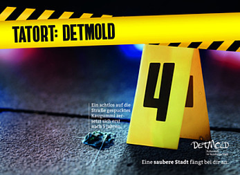 "Tatort: Detmold"-Kampagnenbanner, welches ein Kaugummi auf der Straße zeigt