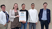 Gruppenaufnahme mit (von links) Katrin Freitag (Schulleiterin), Lehrerin Franziska Altmann (federführende Kollegin), den Schülern Mutaa und Birhad und Michael Düchting als Vertreter von Fairtrade-School-Deutschland